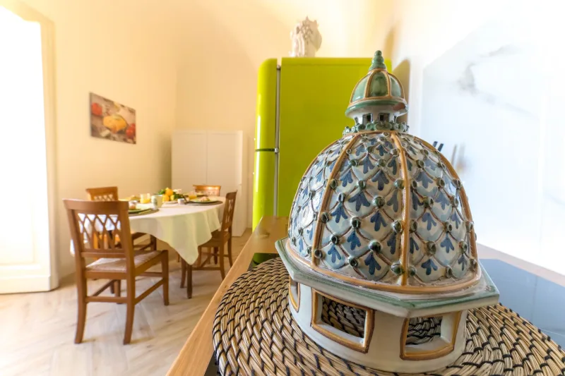Dining table and ceramic Caltagirone dome by the kitchen