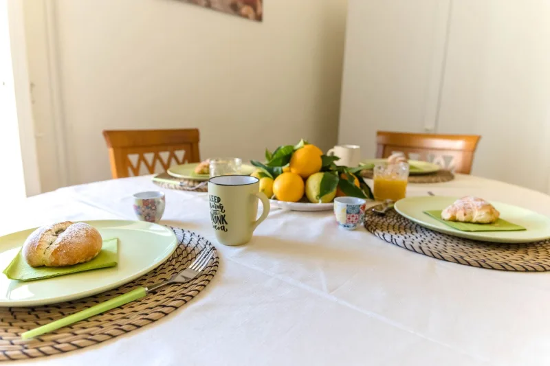 Breakfast table with bread, oranges and juice