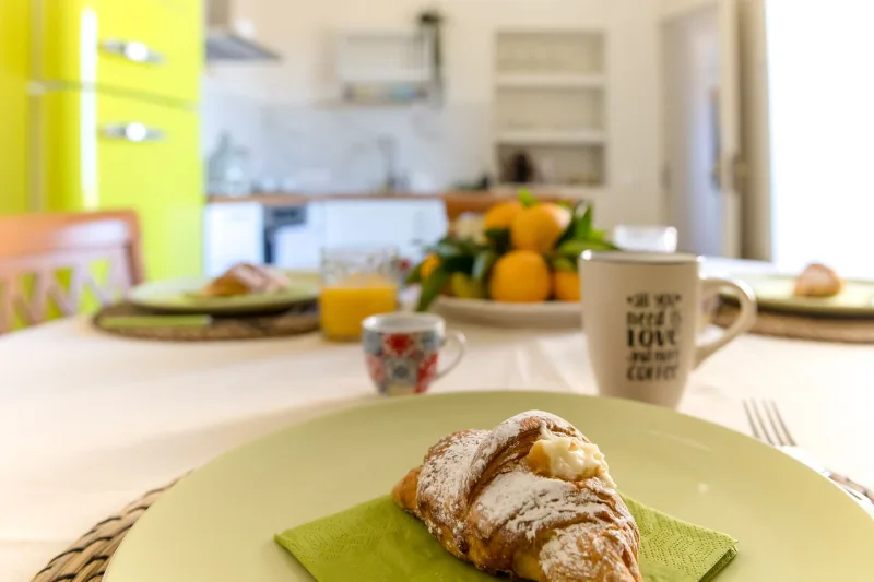 Breakfast croissant and coffee on the dining table