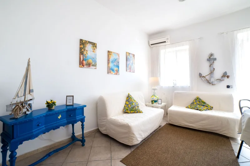 Living room with white sofas and blue console