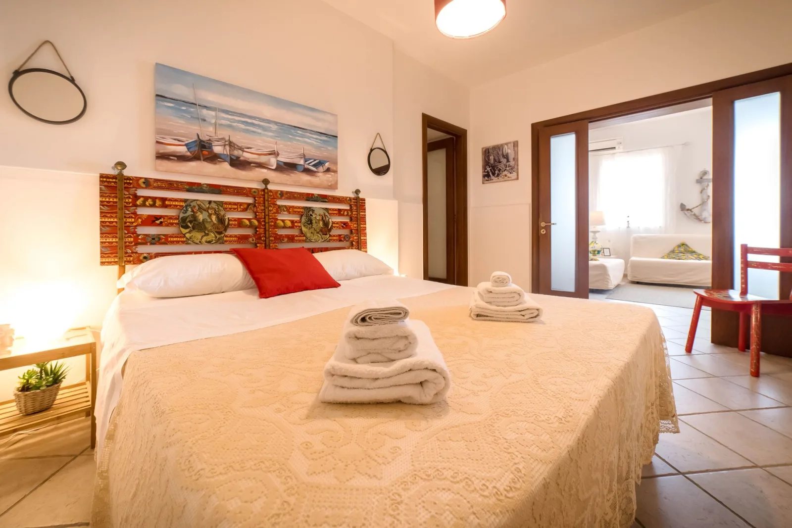 Bedroom with painted Sicilian cart headboard