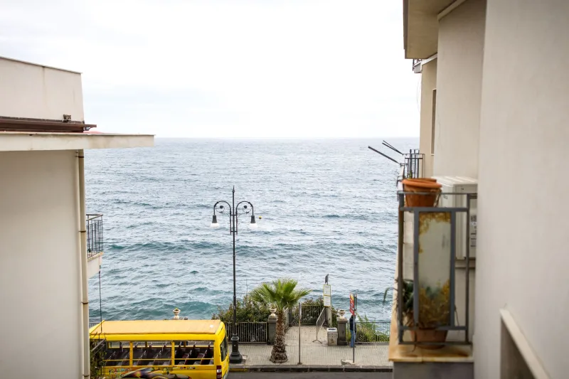 The sea and the seafront promenade at Aci Castello