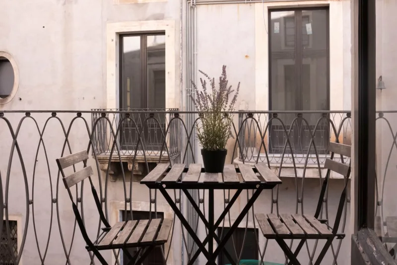 Balcony with bistro table and chairs over the street