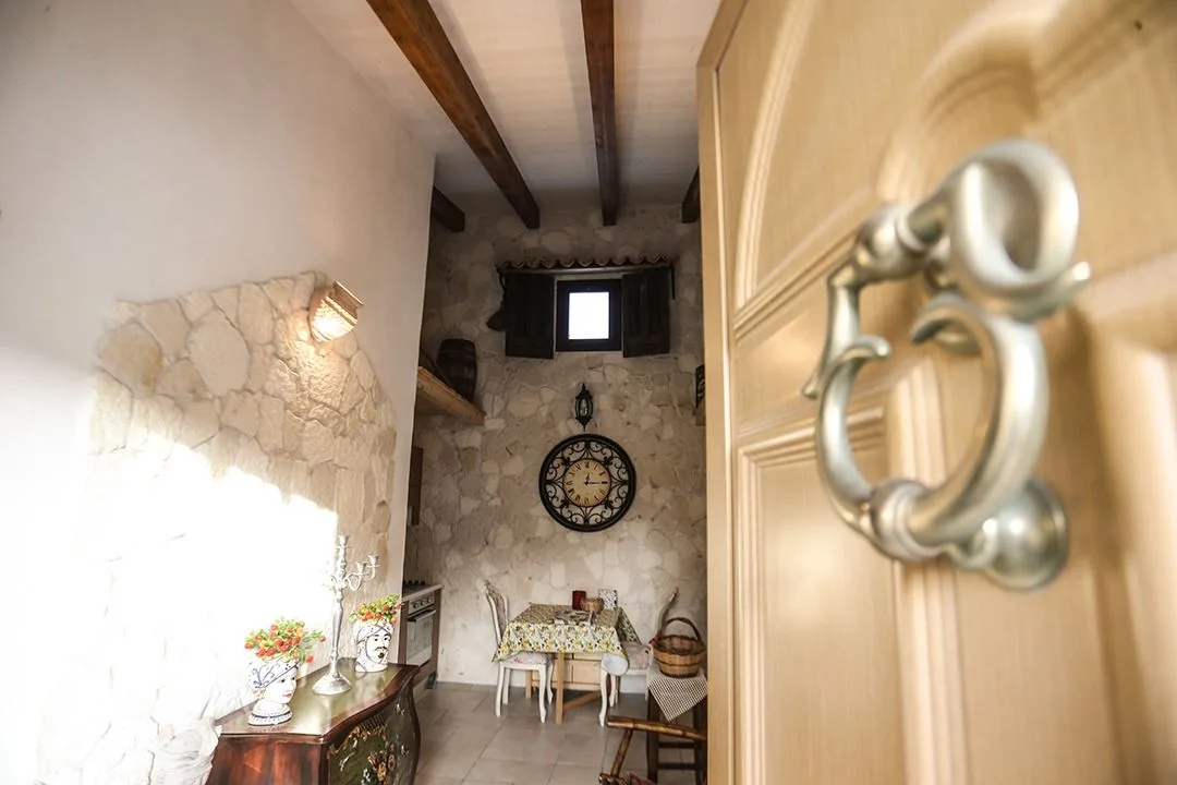 Ornate door handle and stone wall